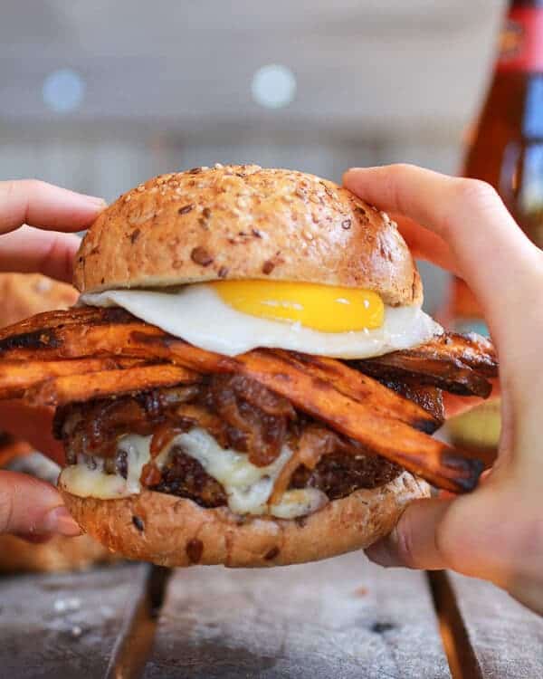 Epic Crispy Quinoa Burgers Topped with Sweet Potato Fries, Beer Caramelized Onions + Gruyere | halfbakedharvest.com