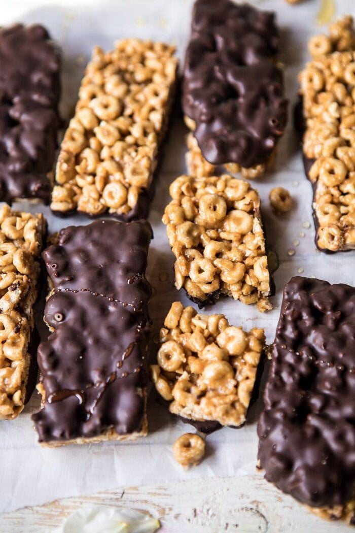 side angle photo of Chocolate Dipped Peanut Butter and Honey Cheerio Bars with one bar broken