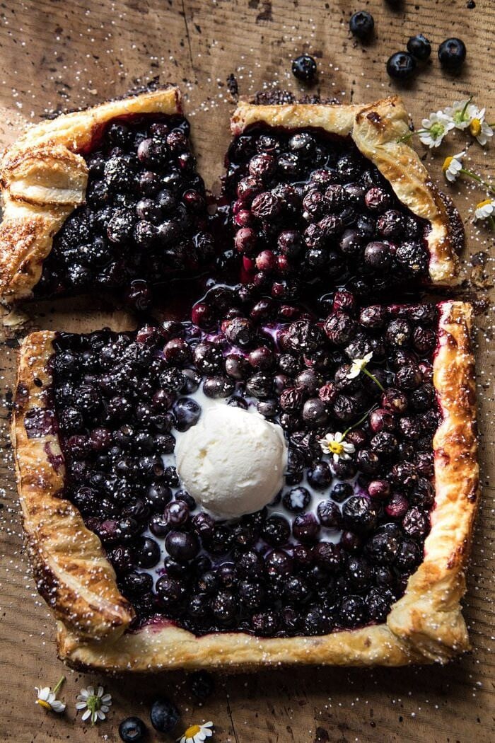 overhead photo of cut int Blueberry Chamomile Galette with ice cream