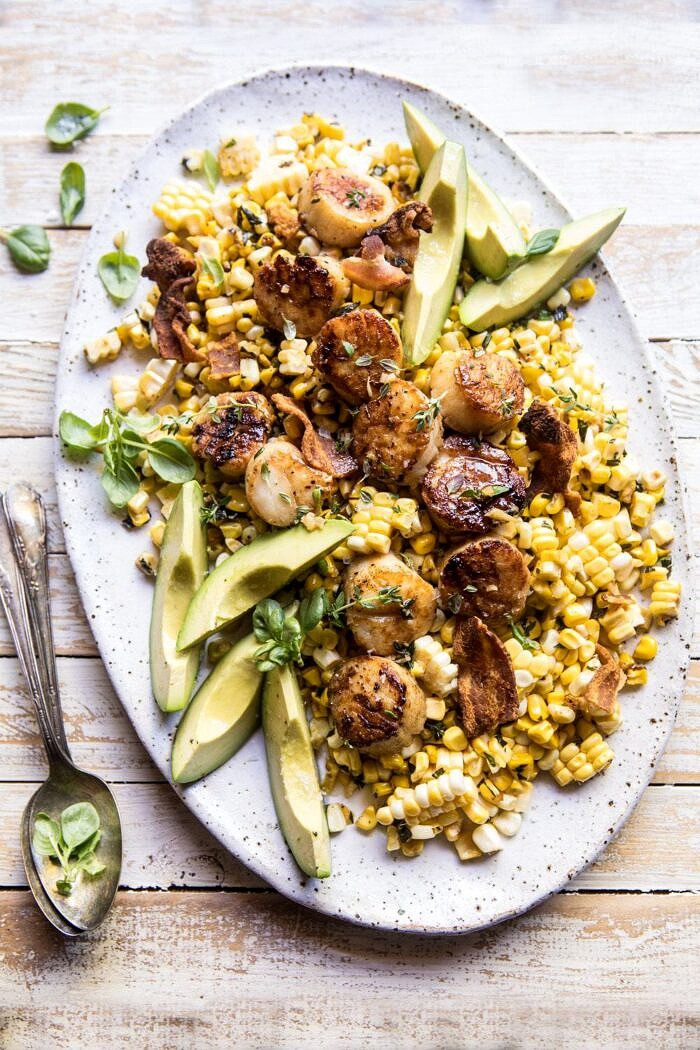 overhead photo of Brown Butter Scallops with Corn, Bacon, and Avocado Salad with basil in photo 