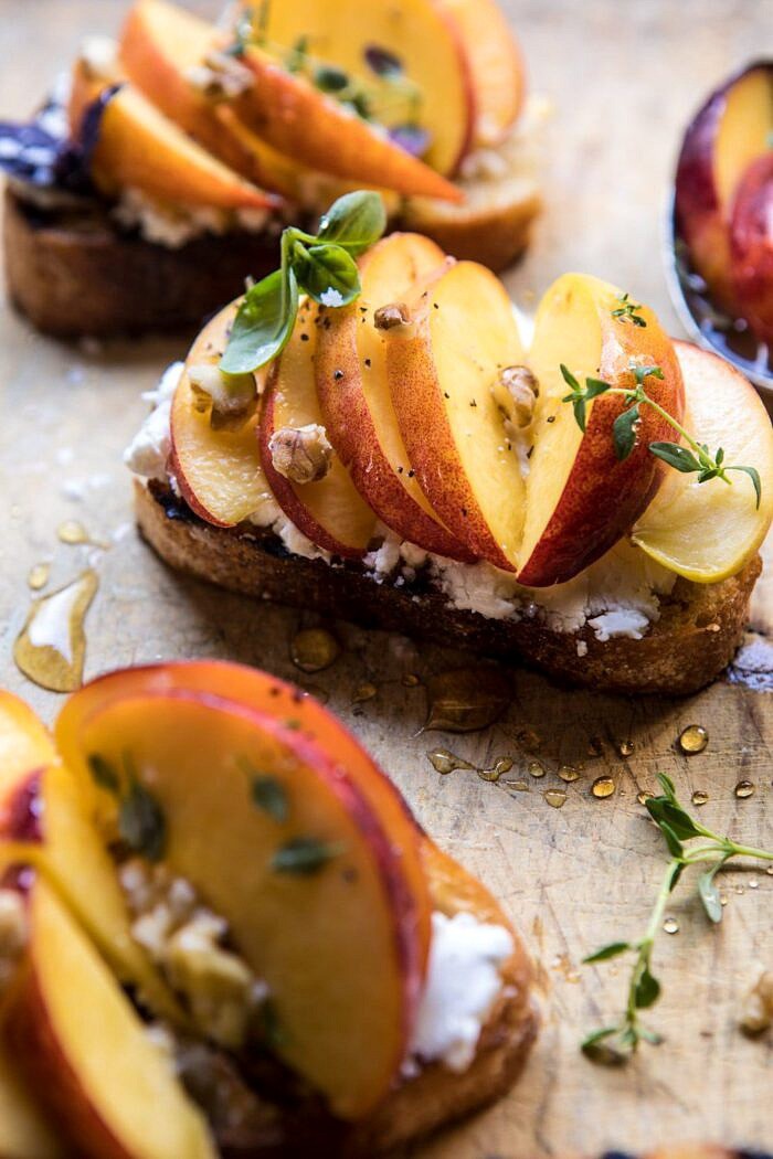close up angled photo of Thyme, Honey, Peach, and Goat Cheese Crostini 
