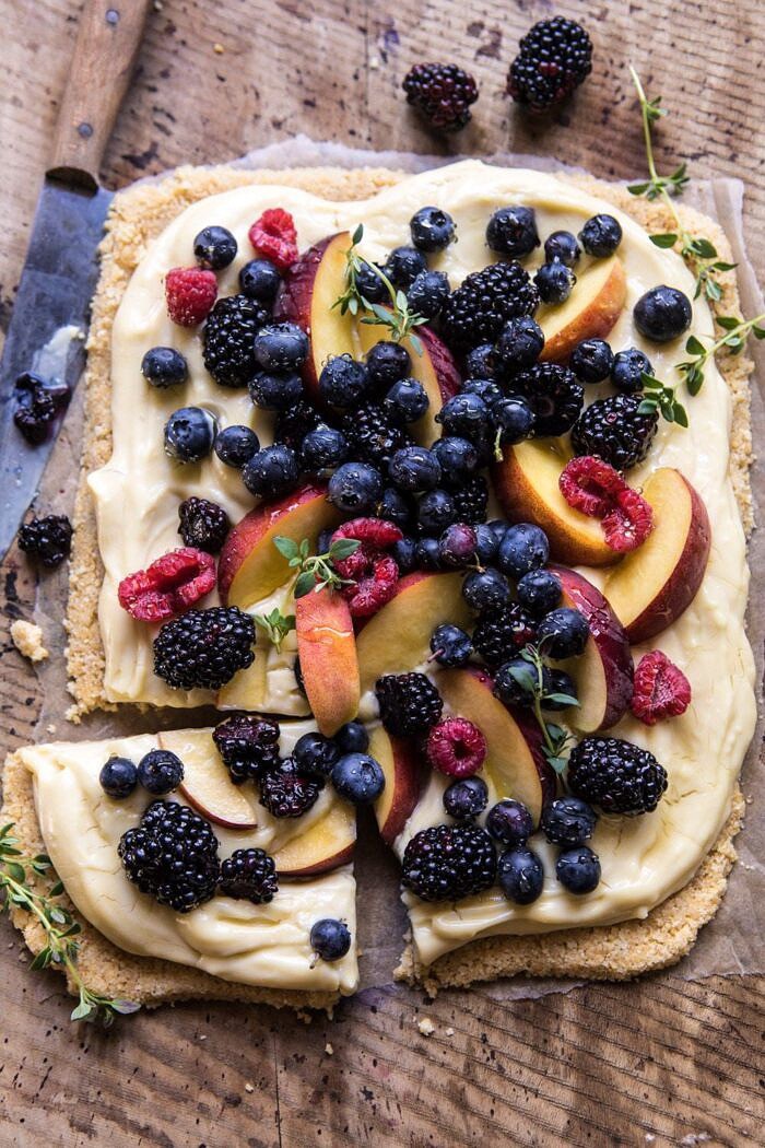 overhead photo of No Bake Mixed Berry Custard Tart with piece cut out an knife in photo