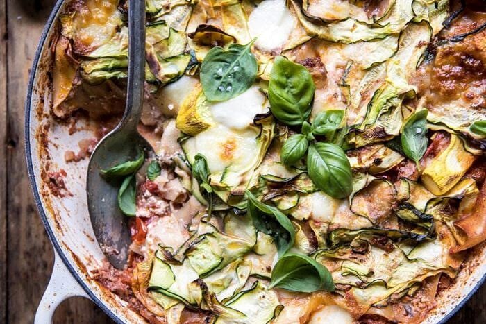 horizontal photo One Pan Zucchini and 3 Cheese Lasagna with spoon in pan