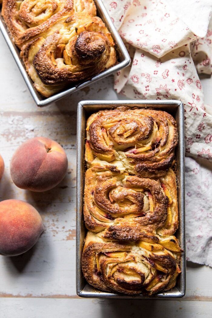 overhead photo of Flaky Pull Apart Cinnamon Peach Brioche Bread on baking pans