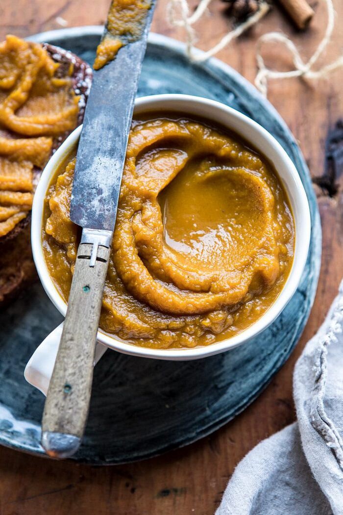 close up photo of 6 Ingredient Spiced Pumpkin Butter with butter knife sitting on bowl 
