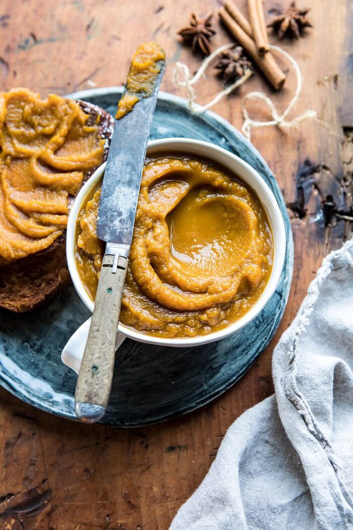 overhead photo of 6 Ingredient Spiced Pumpkin Butter with butter knife resting on bowl 