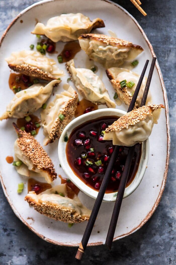 overhead close up photo of Ginger Sesame Chicken Potstickers with Sweet Chili Pomegranate Sauce