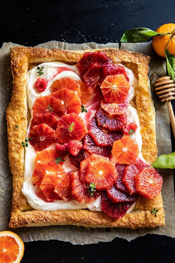 overhead photo of The Simplest Ombrè Citrus Cream Tart with honey drizzler in photo