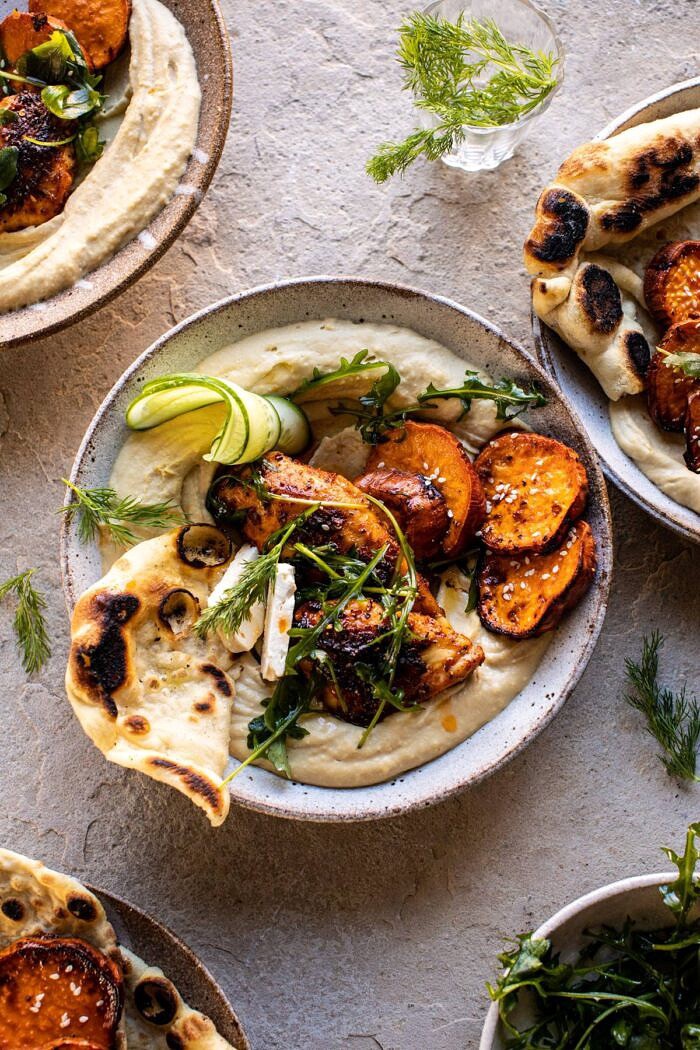 overhead photo of Sheet Pan Chicken Shawarma with Sesame Sweet Potatoes and Hummus in a bowl