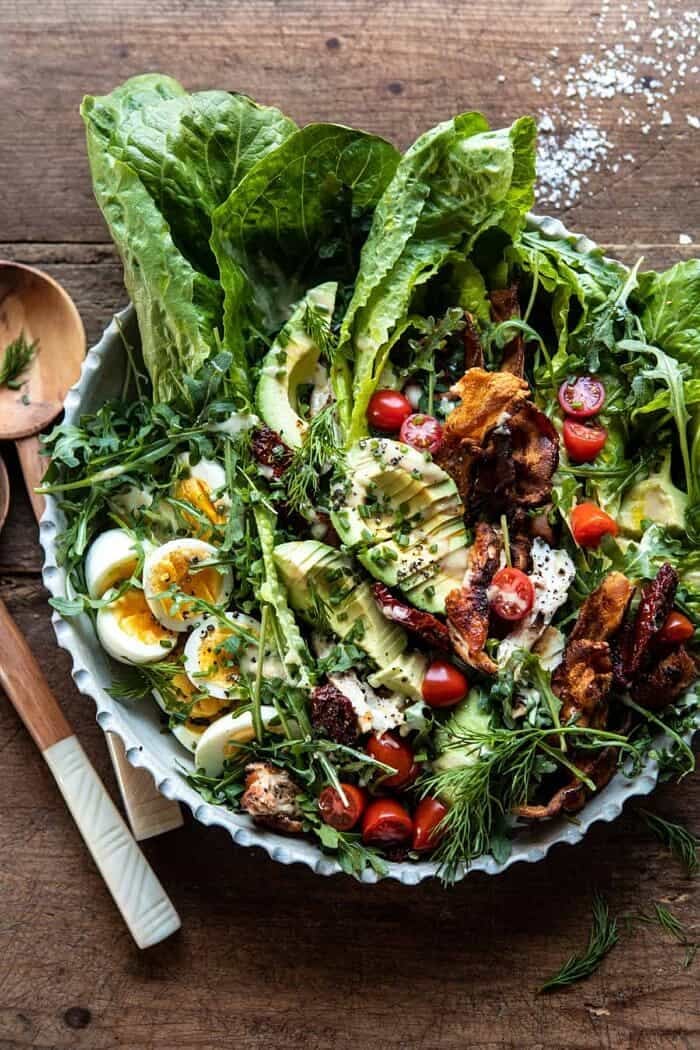 overhead photo of Sun-Dried Tomato Chicken and Avocado Cobb Salad with Tahini Ranch