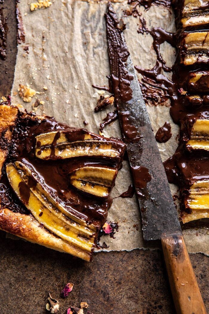 overhead photo of Warm Chocolate Banana Galette square with knife in photo and melted chocolate on knife
