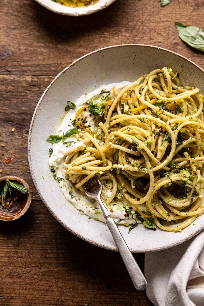overhead close up photo of Broccoli Pesto Pasta with Whipped Ricotta and fork in bowl