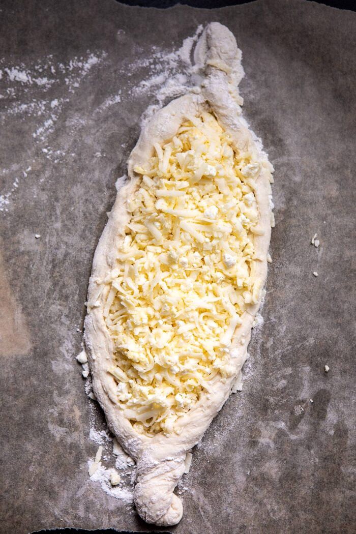 Khachapuri (Georgian Cheese Bread) with cheese before adding kale and before baking