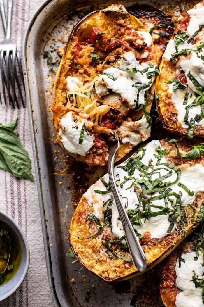 overhead close up photo of Spicy Tomato Parmesan Stuffed Spaghetti Squash with fork in squash