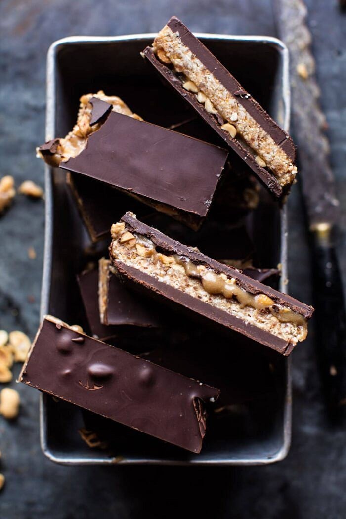 overhead photo of Vegan Gooey Chocolate Coconut Caramel Bars with bite taken out of bar