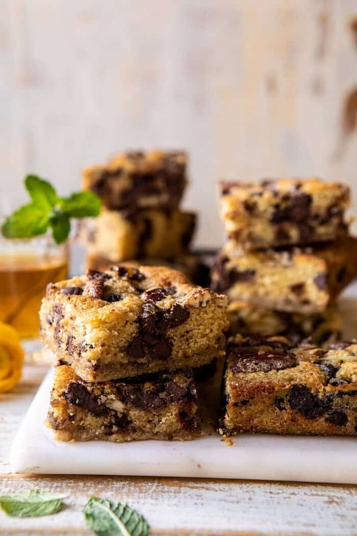 side angled photo of Kentucky Derby Pie Chocolate Chip Cookie Bars stacked on top of each other