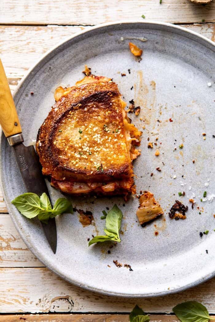 overhead photo of Kimchi Grilled Cheese with half of the sandwich missing