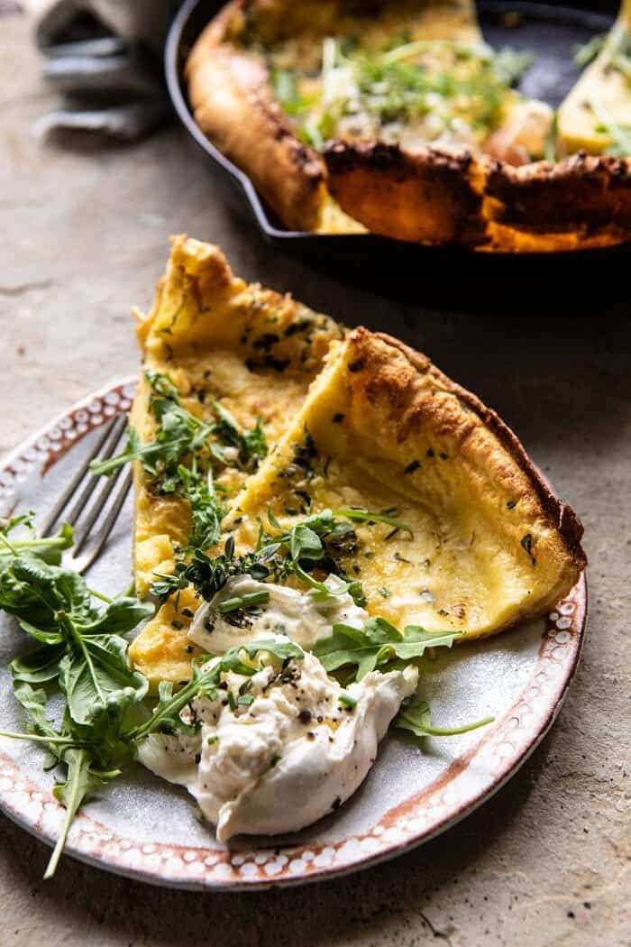 Savory Herb Butter Dutch Baby slices on plate