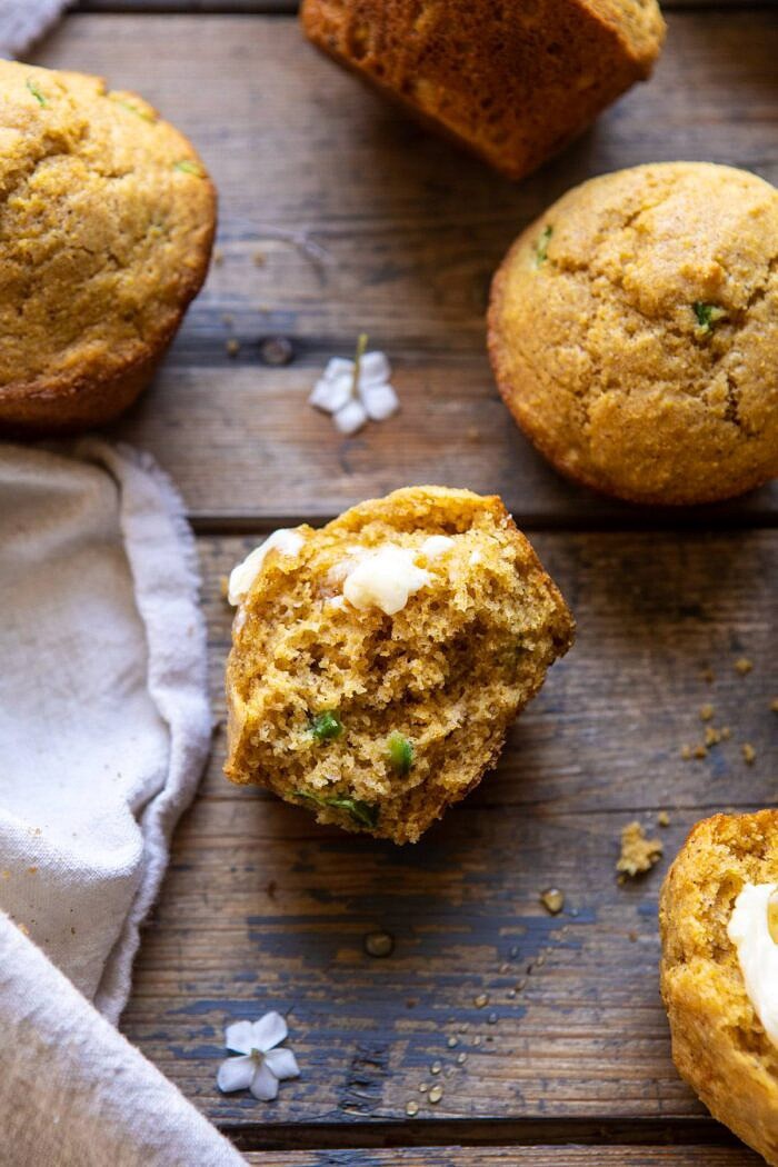Browned Butter Jalapeño Cornbread Muffin broken in half with butter on muffin