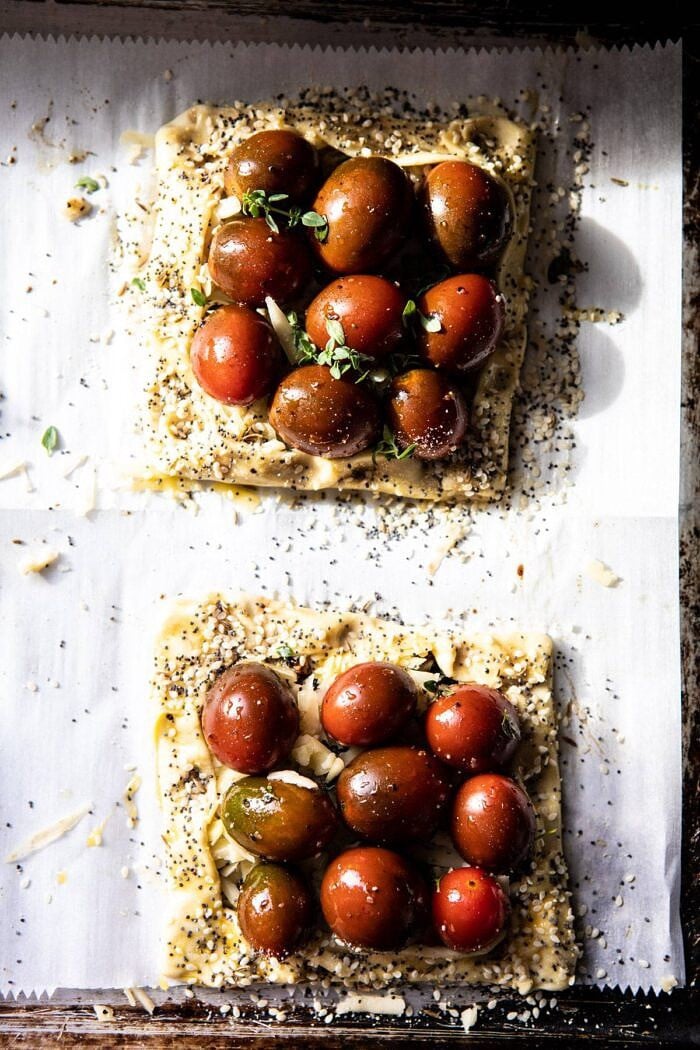 overhead photo of Caramelized Onion and Balsamic Tomato Tarts on baking sheet before baking