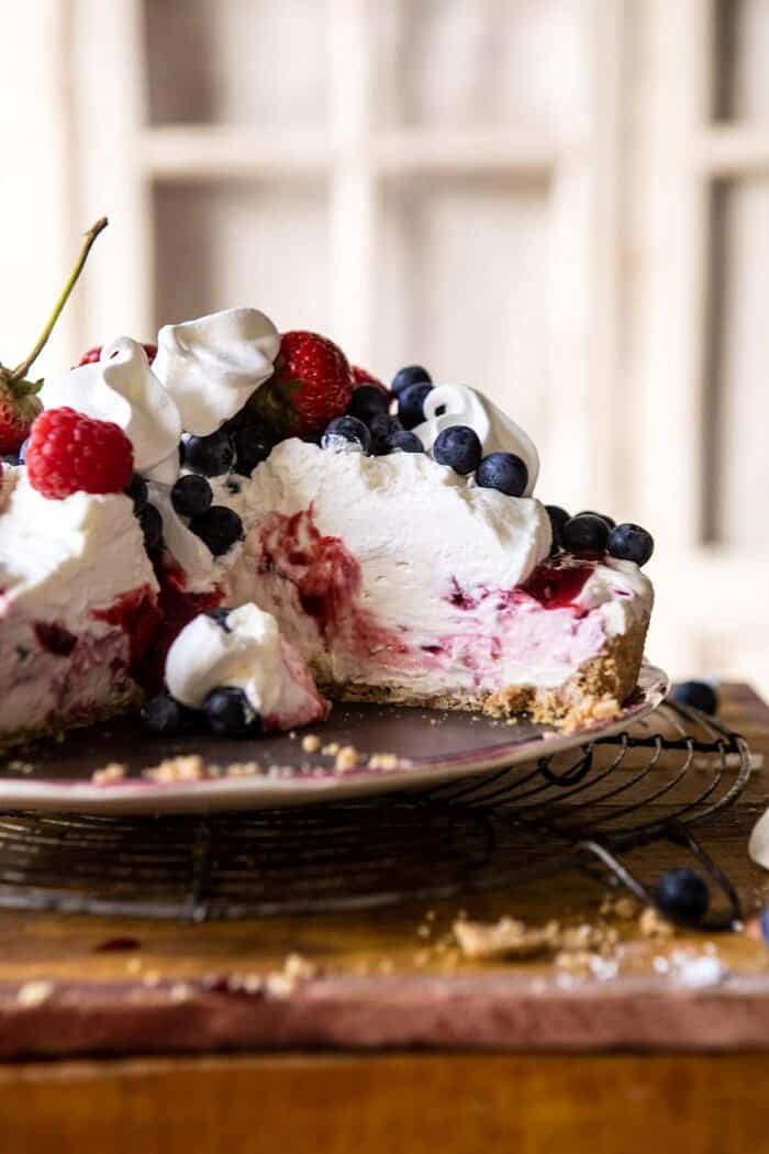 head on photo of No-Bake Eton Mess Berry Cheesecake with slice removed from cake