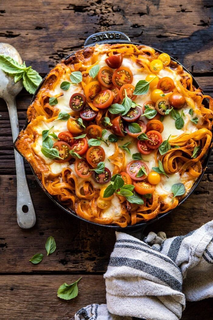 overhead photo of One Pot 30 Minute Creamy Tomato Basil Pasta Bake with spoon next to skillet