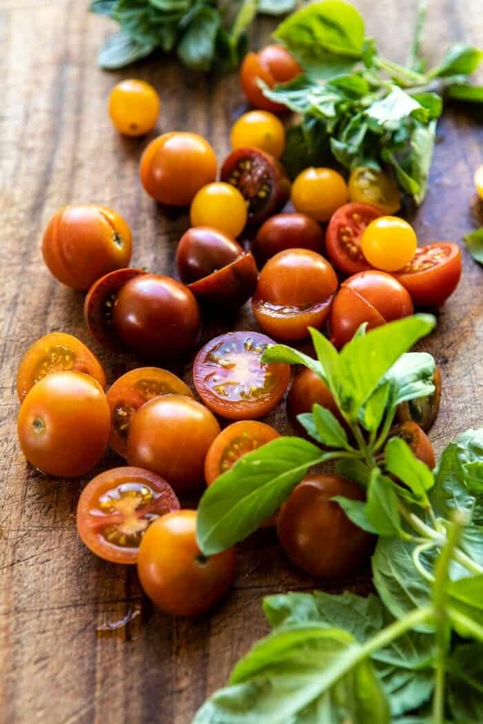 fresh tomatoes and basil on cutting board