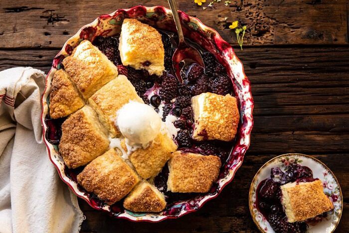 horizontal photo of Blackberry Lavender Cobbler with spoon in baking dish