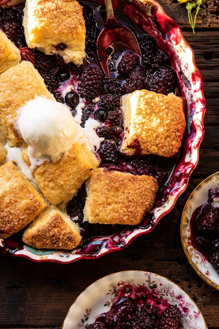 overhead close up photo of Blackberry Lavender Cobbler with ice cream in baking dish