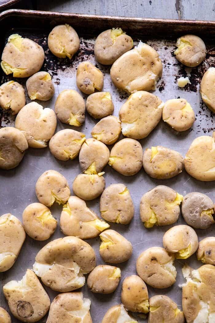 potatoes smashed on baking sheet before roasting