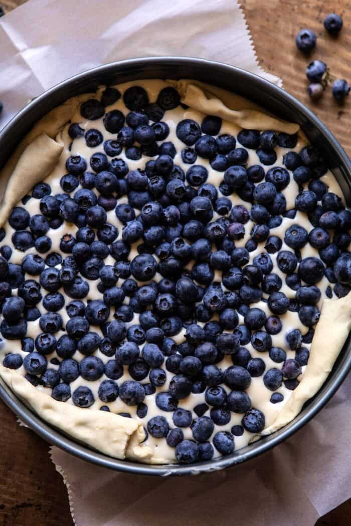 overhead photo of Simple Blueberry Basque Cheesecake in spring form pan before baking 