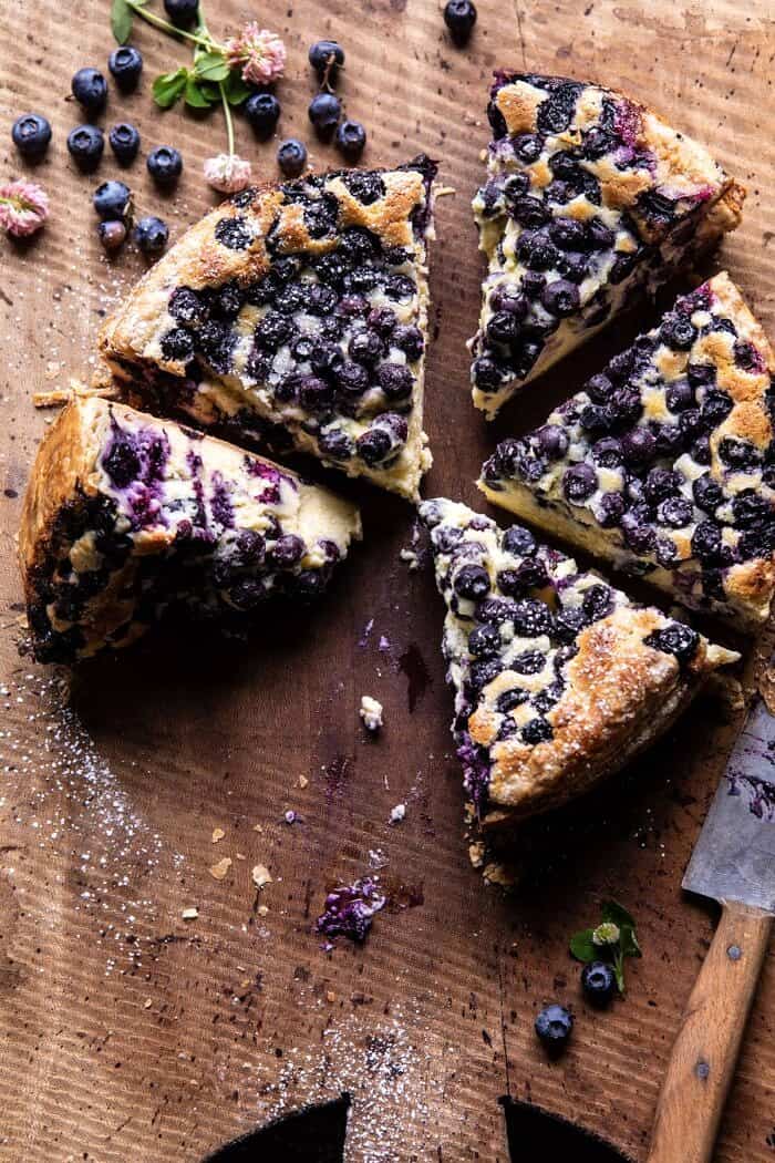 overhead photo of Simple Blueberry Basque Cheesecake with 2 slices missing from cake