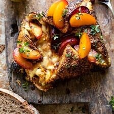 Pastry Wrapped Baked Brie with Thyme Butter Roasted Plums | halfbakedharvest.com #brie #easyrecipes #appetizer #summer #fall