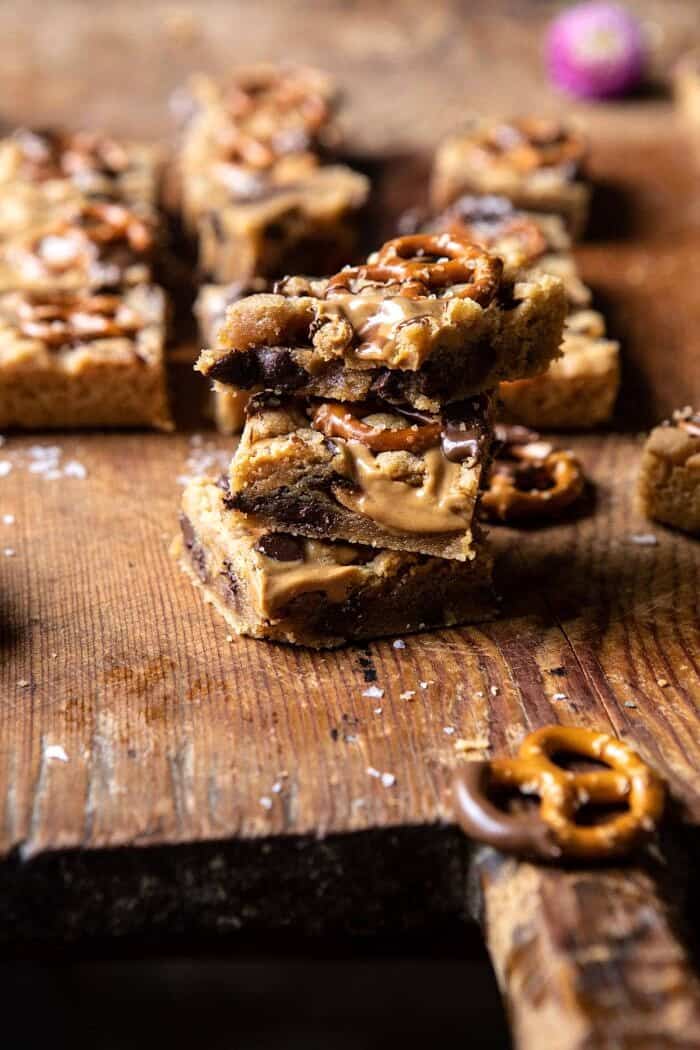 side angled photo of Chocolate Peanut Butter Pretzel Blondies stacked on top of each other