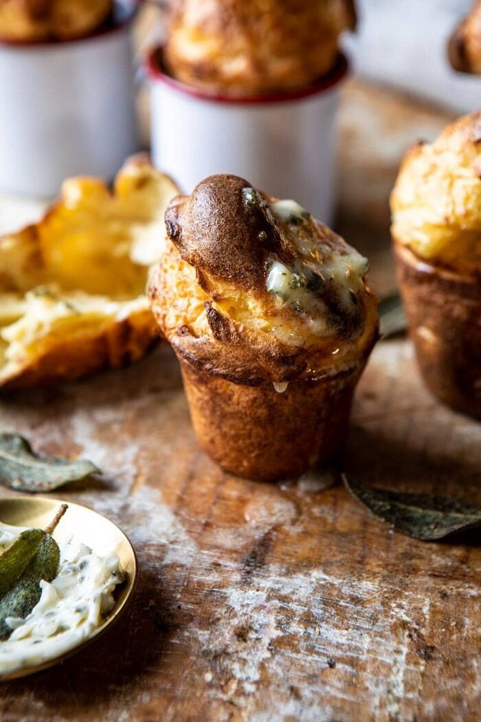 side angle close up photo of Parmesan Popovers with Crispy Sage Garlic Butter