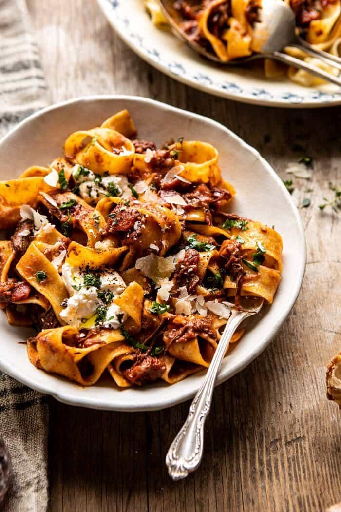 side angled photo of Slow Cooker Red Wine Sunday Ragu Pasta with fork in bowl 