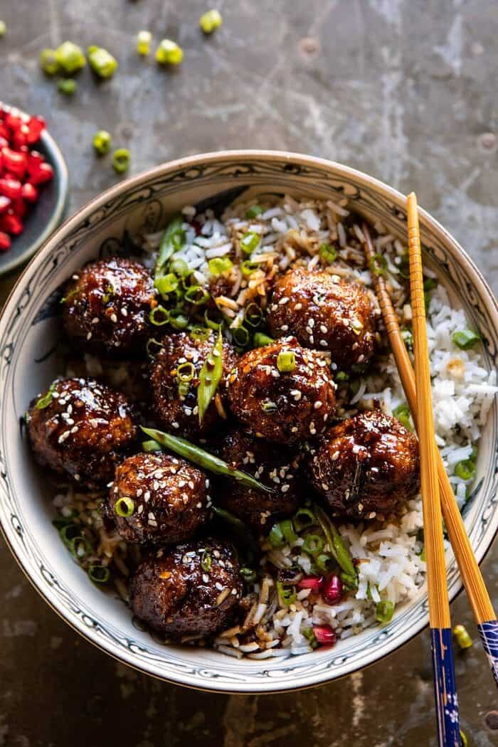 overhead close up photo of Weeknight Sticky Ginger Sesame Chicken Meatballs in bowl of rice