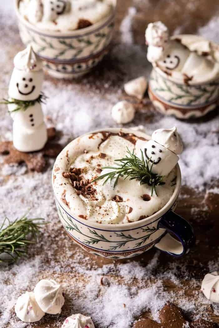 overhead photo of Creamy Coconut Hot Chocolate with melting snowman marshmallow in hot cocoa