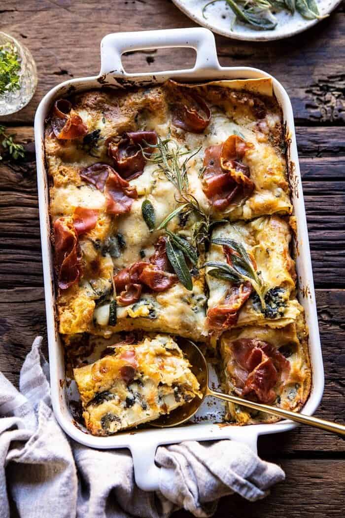 overhead photo of Roasted Butternut Squash and Spinach Lasagna with serving of lasagna removed and spoon in dish