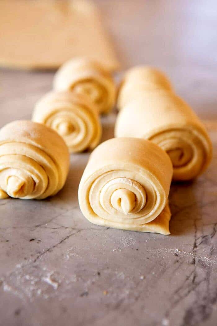 side angled, close up photo of Salted Honey Butter Parker House Roll dough before baking, process shot 