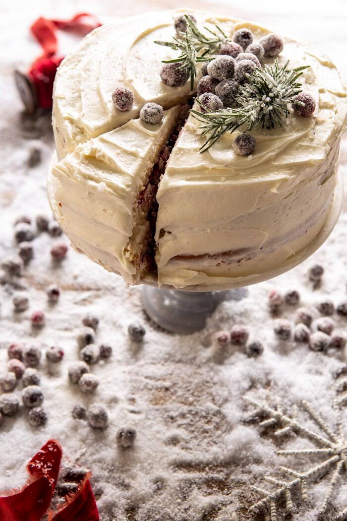 side angled photo of White Christmas Cranberry Layer Cake with 1 slice cut in cake