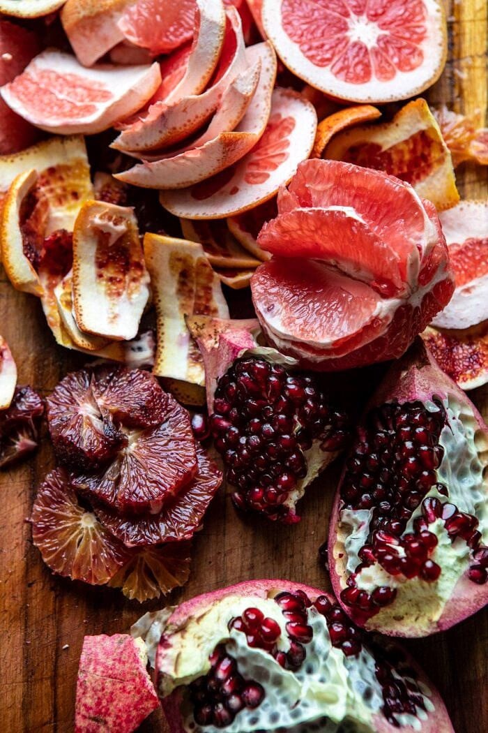 pomegranates and citrus on cutting board