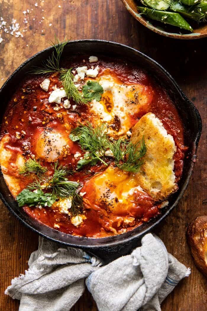 overhead photo of Eggs in Purgatory with Chile Butter and Feta and toast in eggs to break the yolk