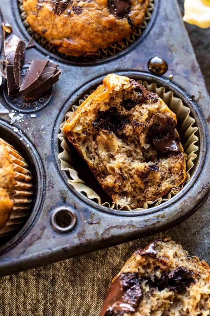 side angled close up of One Bowl Chocolate Chunk Chai Banana Muffins bitten in half 