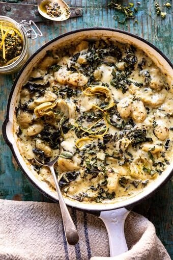 Skillet Baked Creamy Pesto Spinach and Artichoke Gnocchi | halfbakedharvest.com #gnocchi #easyrecipes #oneskillet