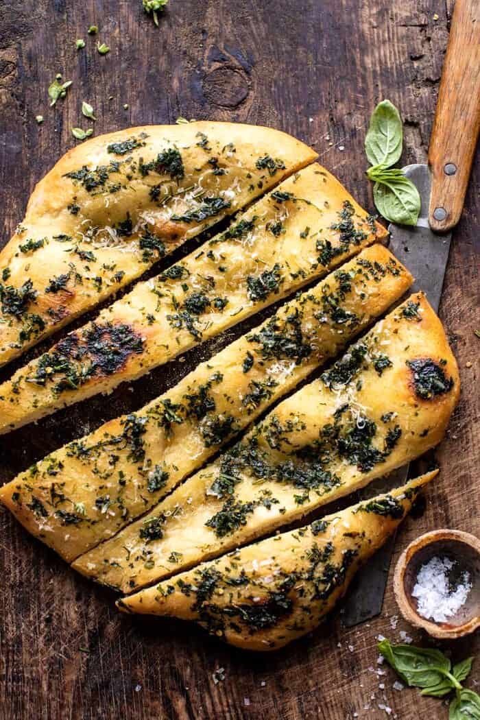 overhead photo of No Knead Rosemary Garlic Parmesan Bread with bread slices cut 