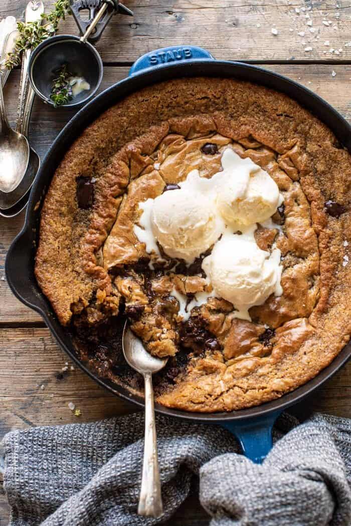 overhead photo of Crinkle Top Chocolate Peanut Butter Skillet Blondies with ice cream on top and spoon in blondie