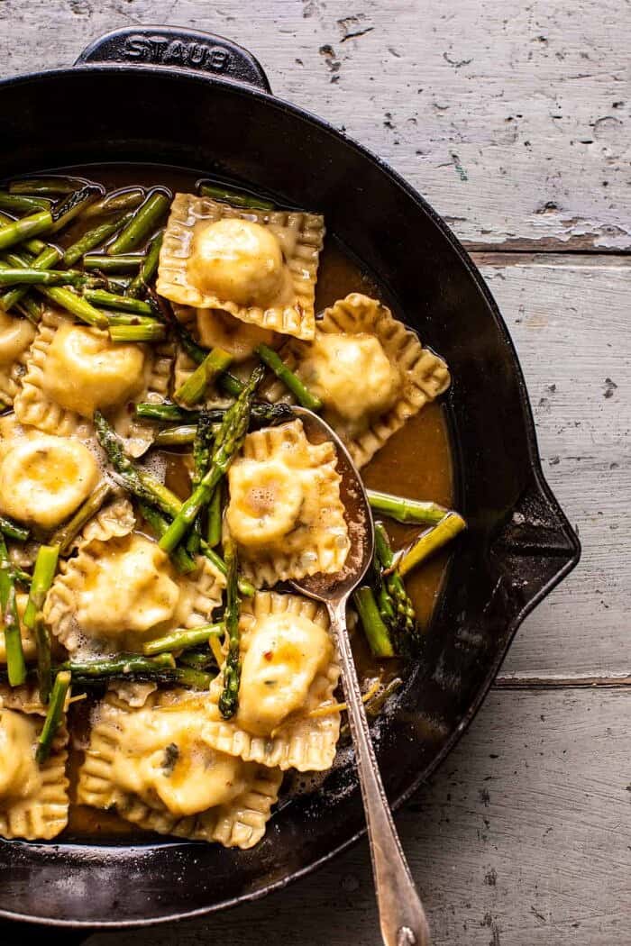 overhead photo of Lemon Butter Cheese Ravioli with asparagus in skillet 