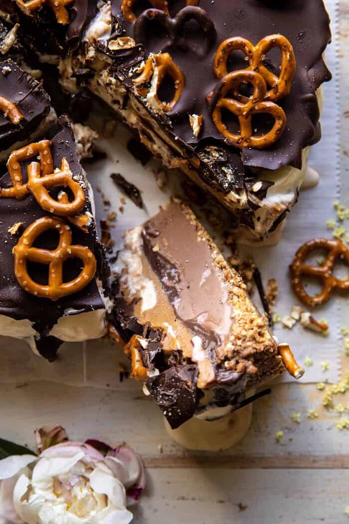 overhead close up photo of Fudgy Chocolate Peanut Butter Ice Cream Pretzel Cake slice