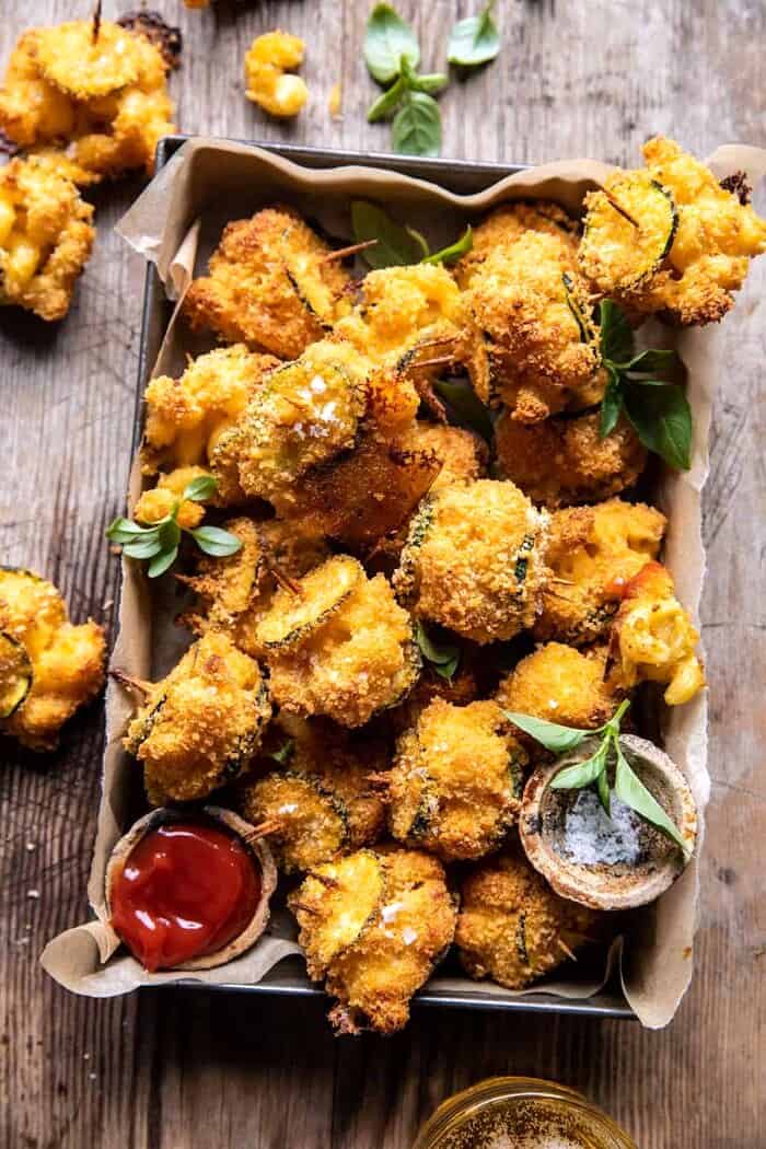 overhead photo of Mac and Cheese Stuffed Oven Fried Zucchini Bites in serving basket